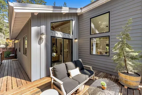 a front view of a house with outdoor seating