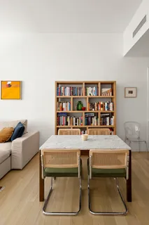 a view of a workspace with furniture and a bookshelf