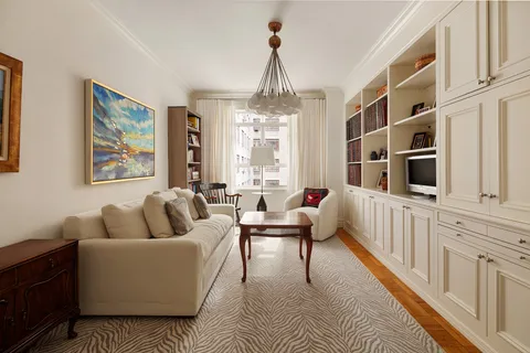 a living room with furniture fireplace and a large window