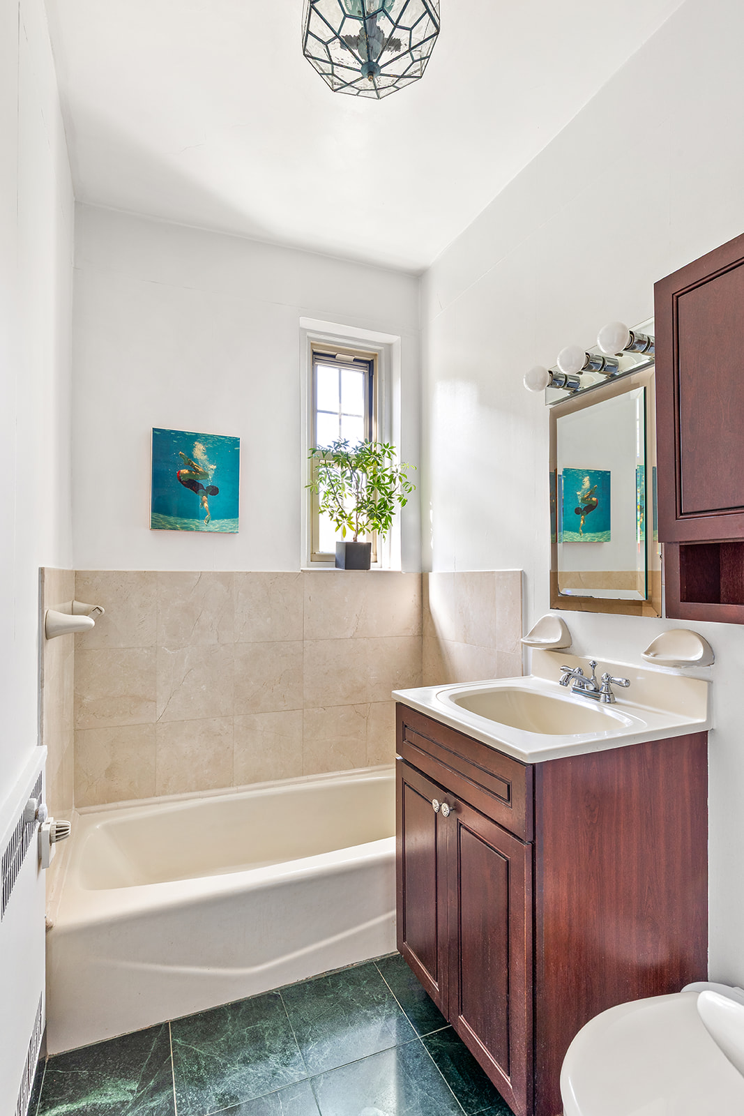 145 Hicks Street, Unit B40 Brooklyn, NY 11201 - Photo 8 of 10 a bathroom with a tub sink and mirror