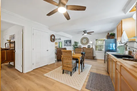 a view of a bathroom with a sink and mirror with toilet
