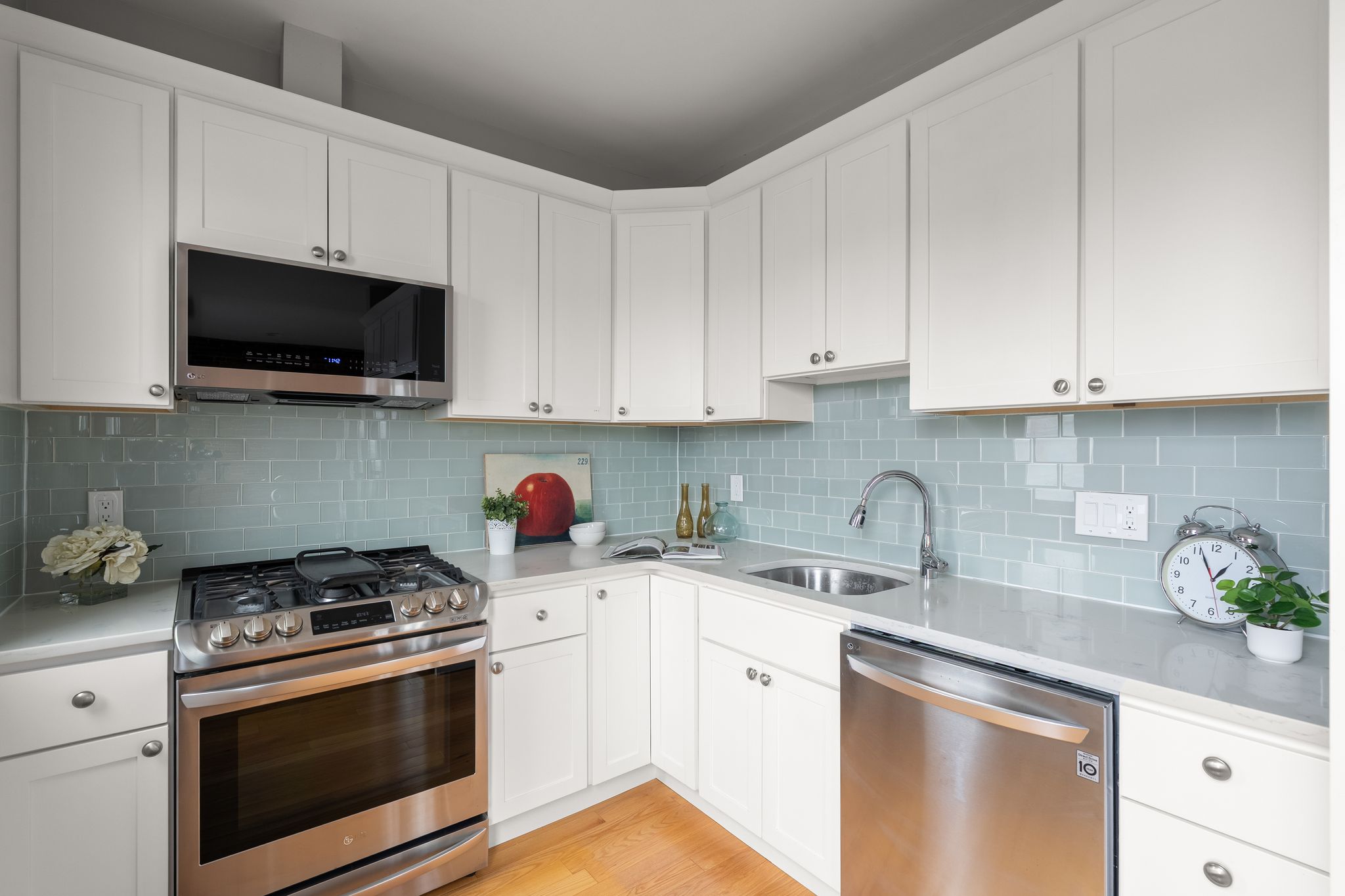 88 Hancock Street, Unit 17 Cambridge, MA 02139 - Photo 5 of 18 a kitchen with white cabinets and appliances
