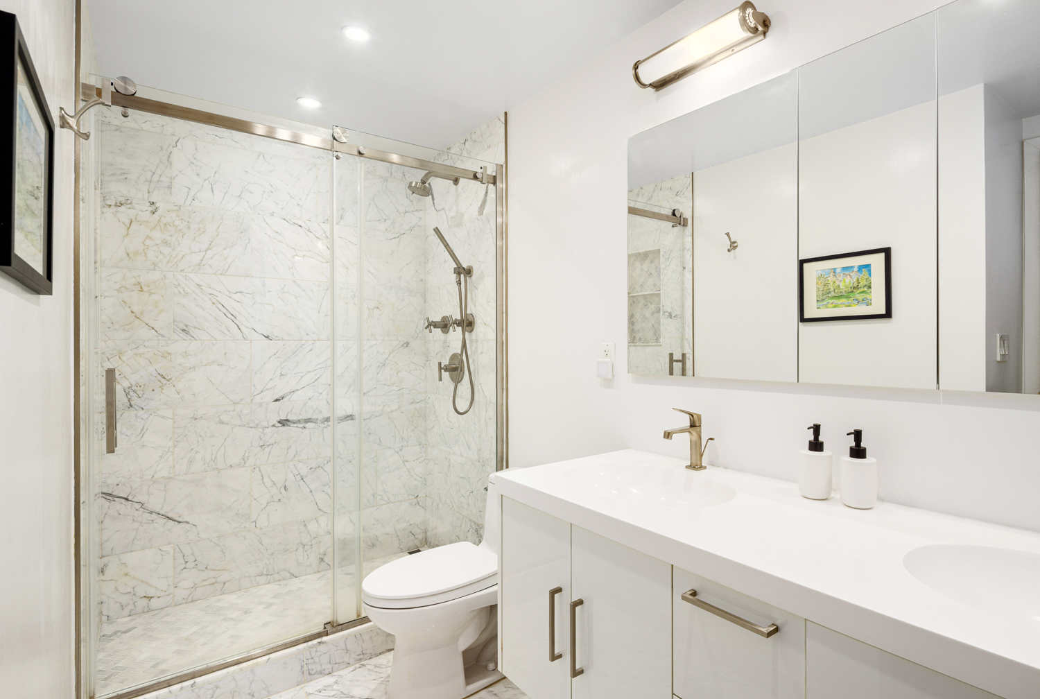 270 West 17th Street, Unit 11BC Manhattan, NY 10011 - Photo 11 of 13 a bathroom with a sink a toilet and shower