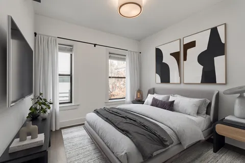 a bedroom with a bed and a couch