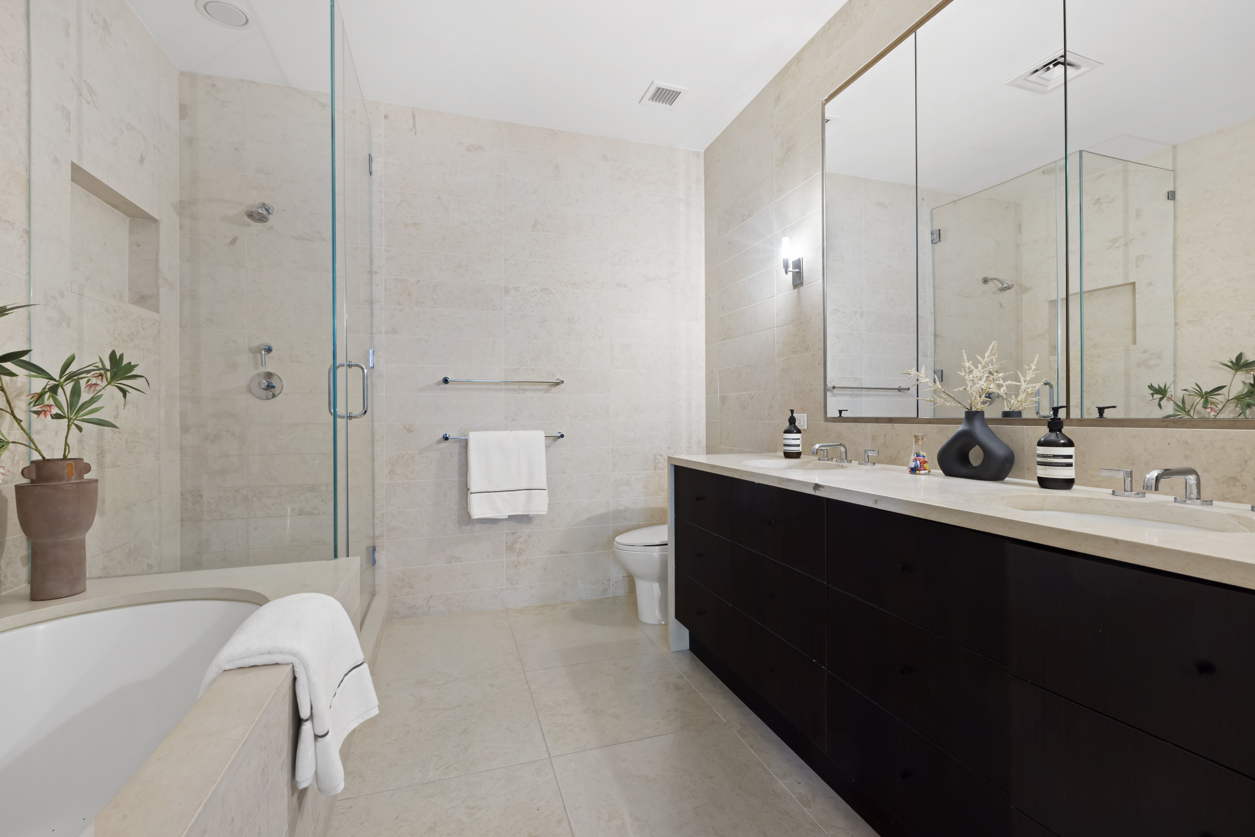 95 Charles Street, Unit TH Manhattan, NY 10014 - Photo 17 of 29 a bathroom with a double vanity sink a toilet and shower
