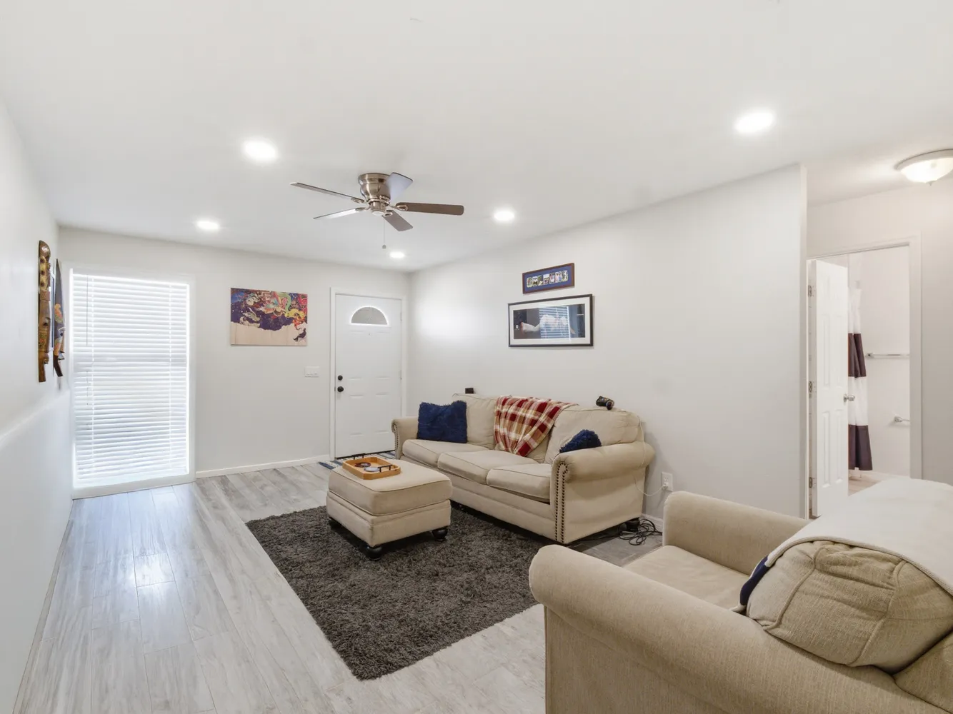 a living room with furniture and wooden floor