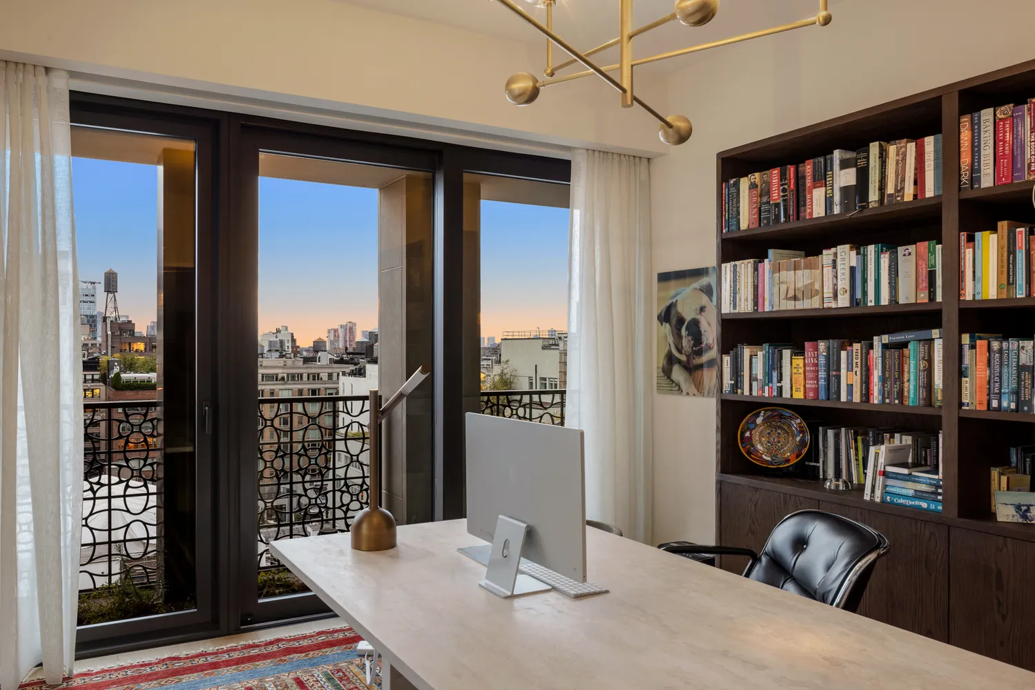 a view of a workspace with furniture and a book shelf