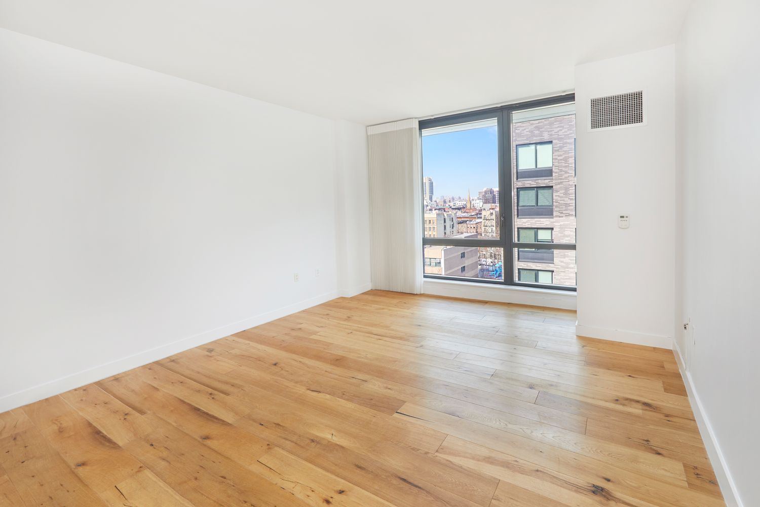 23 West 116th Street, Unit 8A Manhattan, NY 10026 - Photo 2 of 28 a view of an empty room with a window