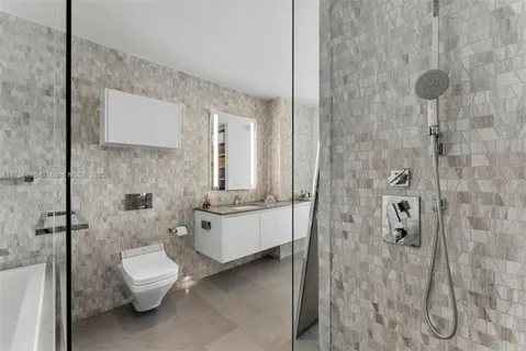 a bathroom with a toilet sink and shower