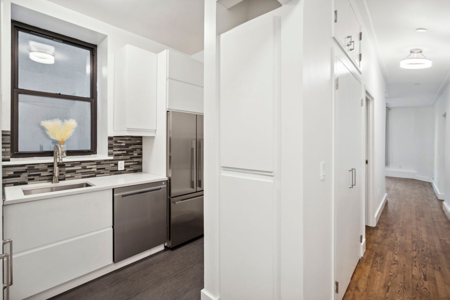 a kitchen with stainless steel appliances granite countertop a refrigerator and a sink