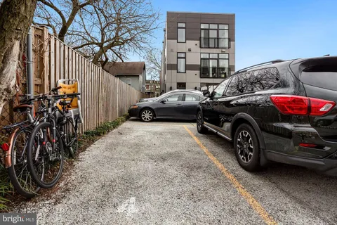 a front view of a residential apartment building with a yard