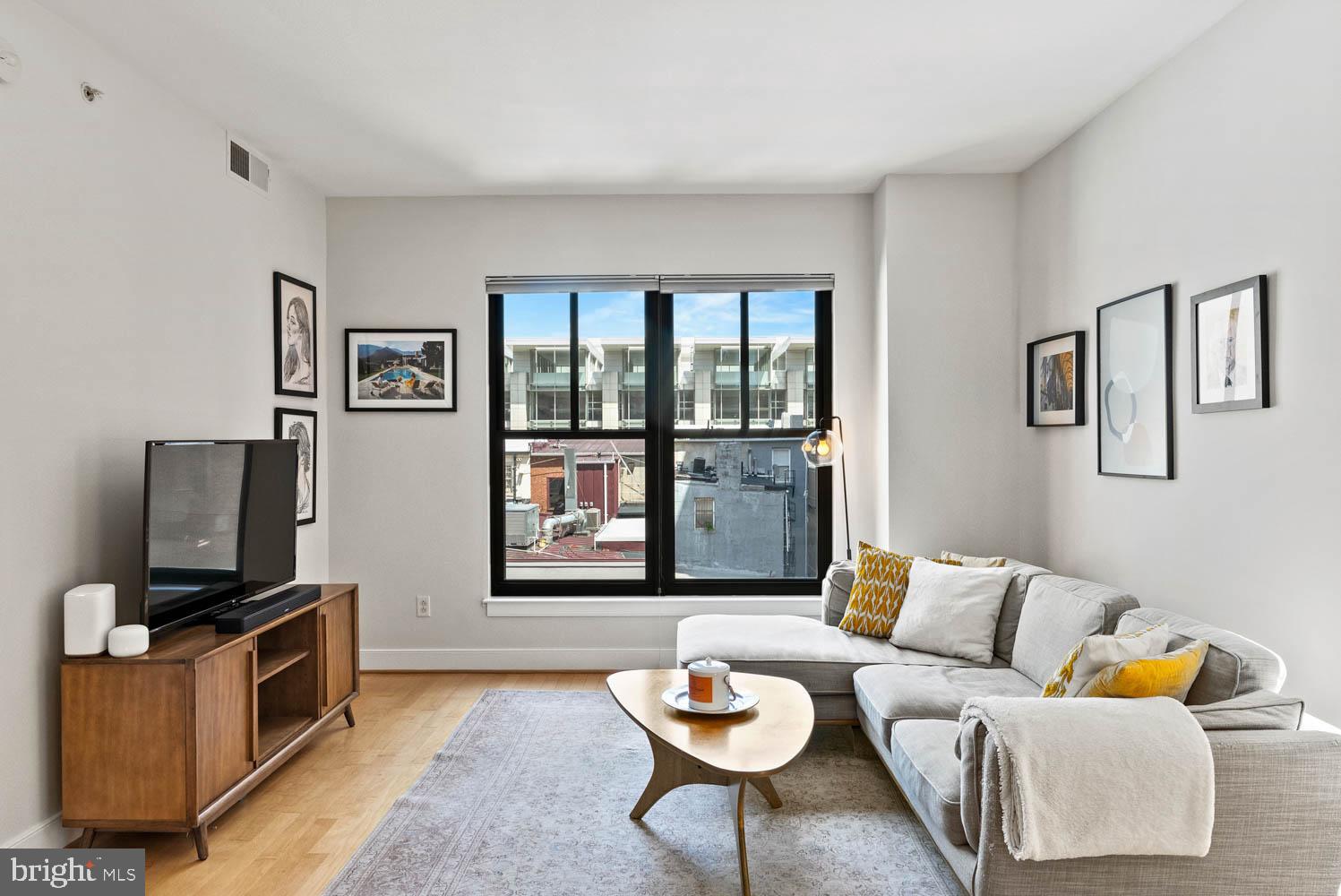 910 M Street Northwest, Unit 403 Washington, DC 20001 - Photo 2 of 31 a living room with furniture and a flat screen tv