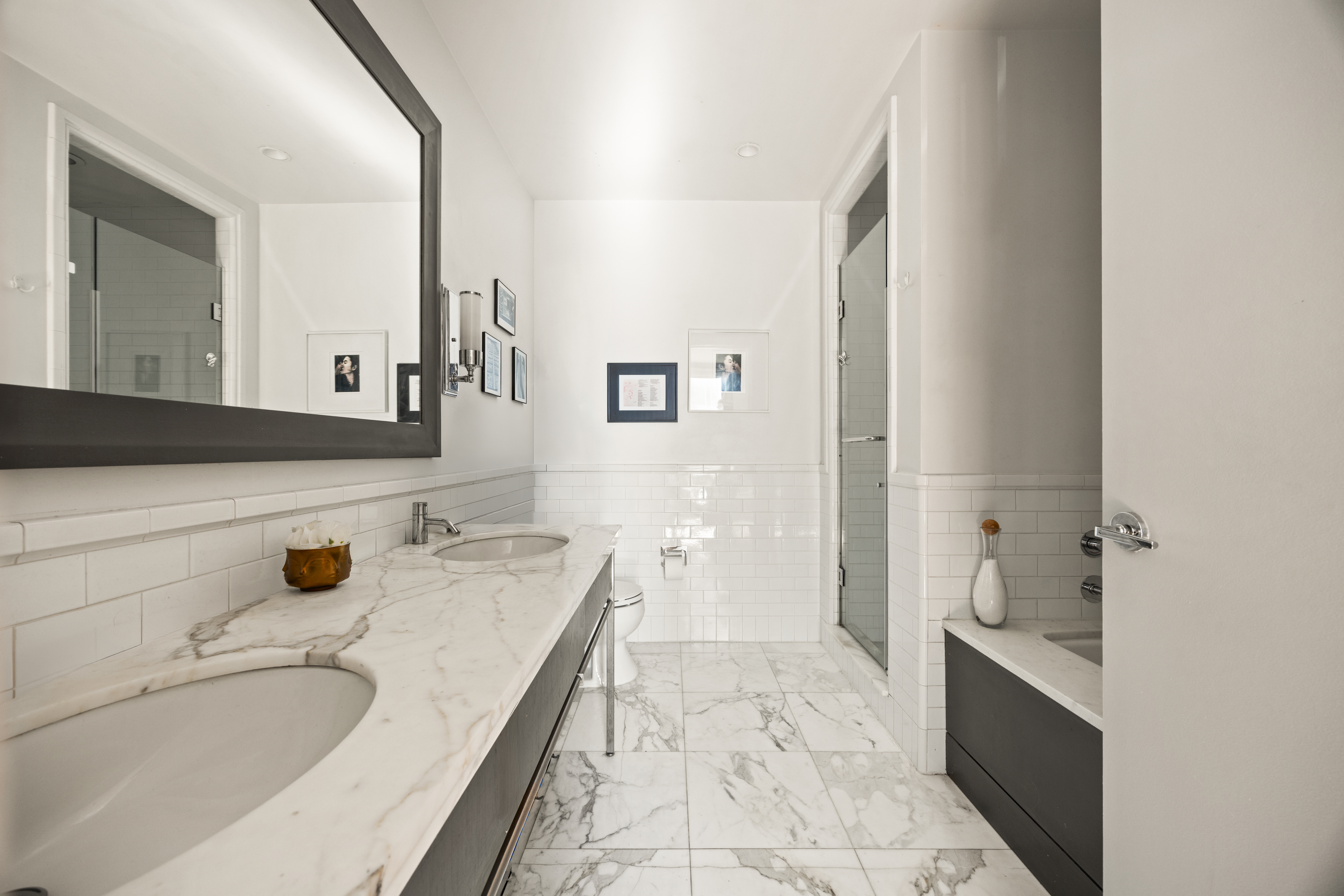150 Nassau Street, Unit 17D Manhattan, NY 10038 - Photo 7 of 16 a bathroom with a granite countertop sink and a mirror