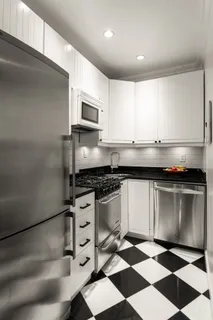 a kitchen with granite countertop stainless steel appliances a sink and cabinets