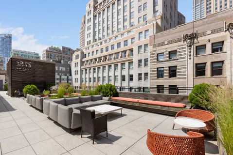 a outdoor space with patio couches and a fireplace