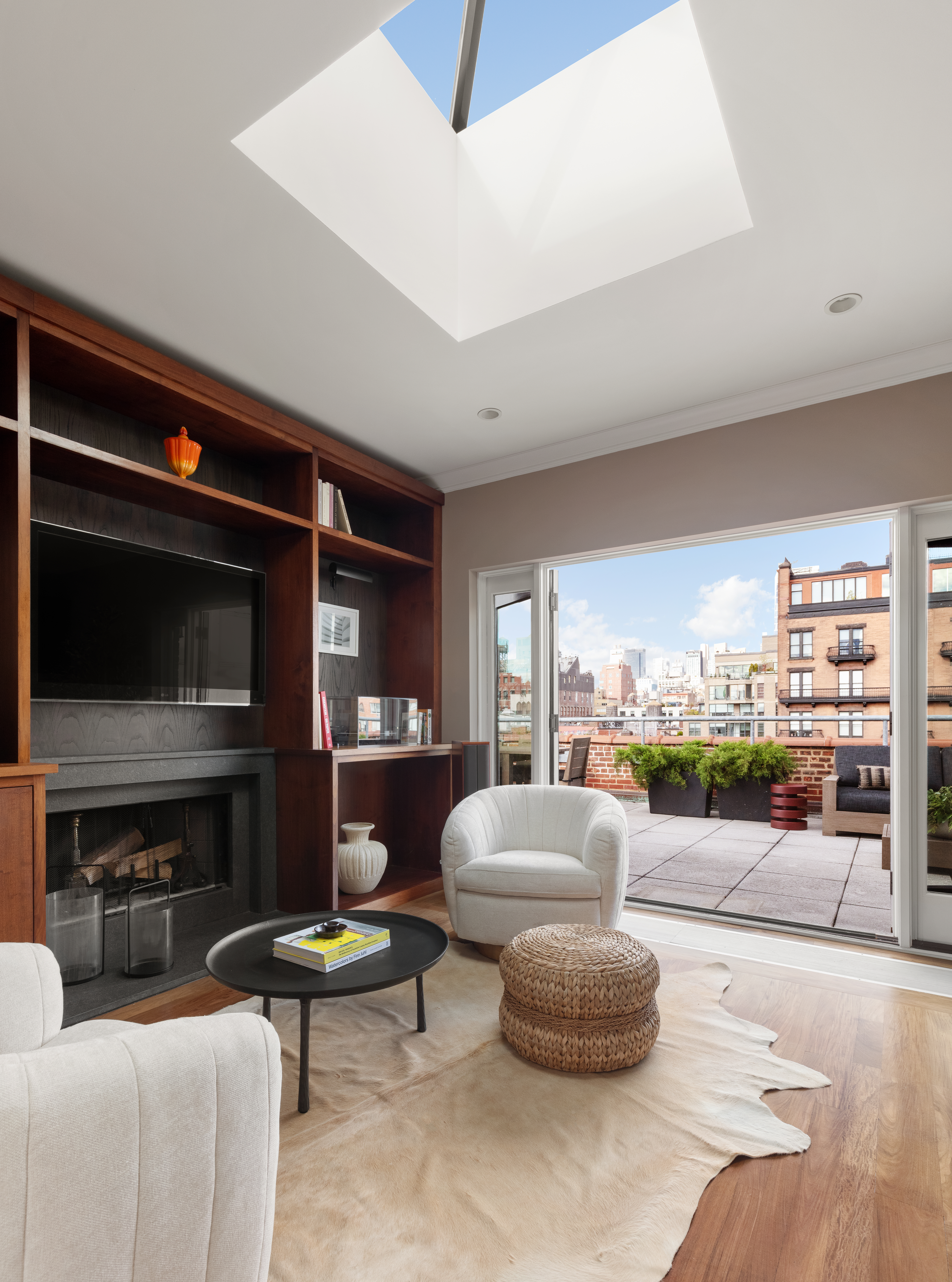 31 West 11th Street Manhattan, NY 10011 - Photo 13 of 21 a living room with furniture a flat screen tv and a fireplace