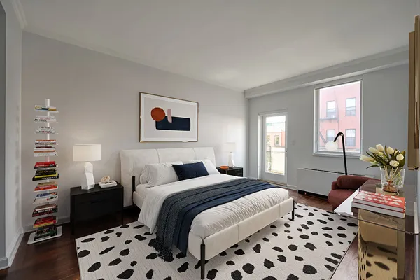 a bedroom with a bed and a lamp
