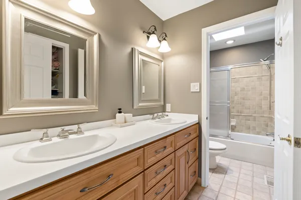 a bathroom with a tub sink and mirror