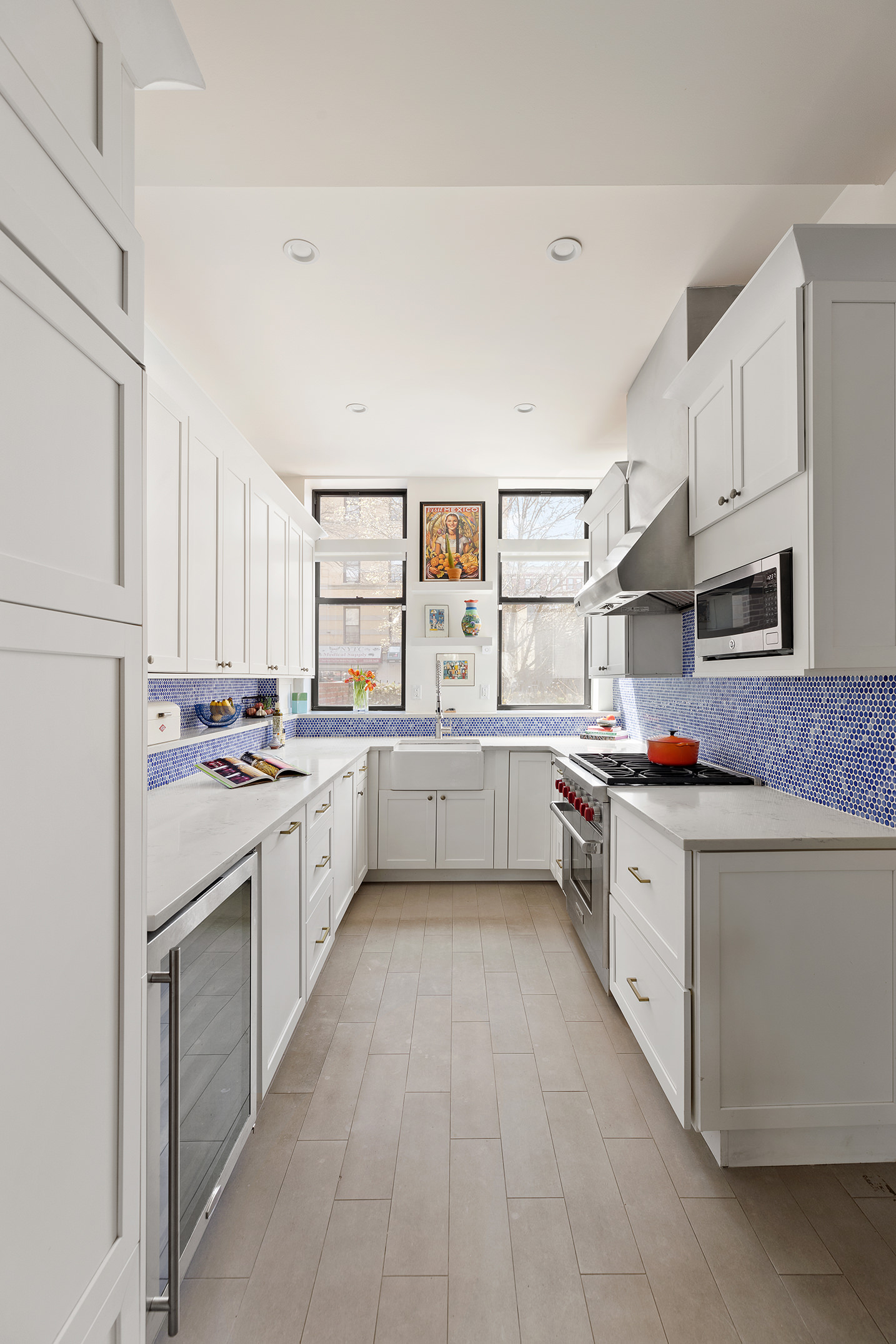 657 West 183rd Street Manhattan, NY 10033 - Photo 4 of 22 a kitchen with stainless steel appliances a sink stove and cabinets