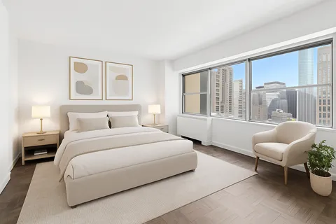 a bedroom with a bed and a large window