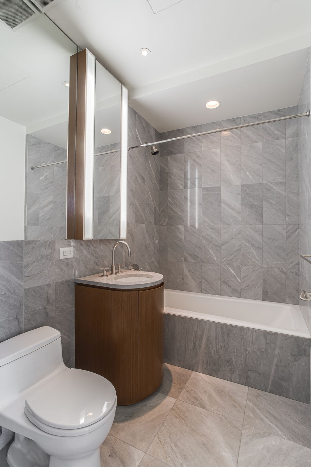 50 United Nations Plaza, Unit 26B Manhattan, NY 10017 - Photo 22 of 25 a bathroom with a sink a toilet and shower