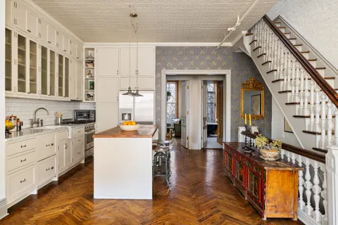 a kitchen with granite countertop a sink a stove and cabinets