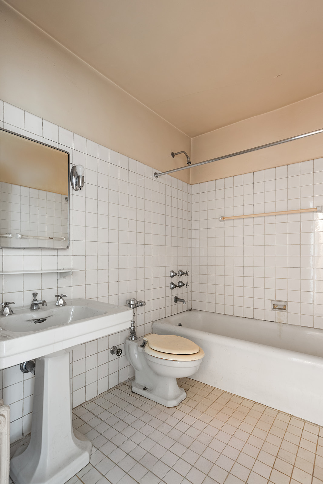 30 Sutton Place, Unit 12E Manhattan, NY 10022 - Photo 7 of 8 a bathroom with a double vanity sink toilet and shower