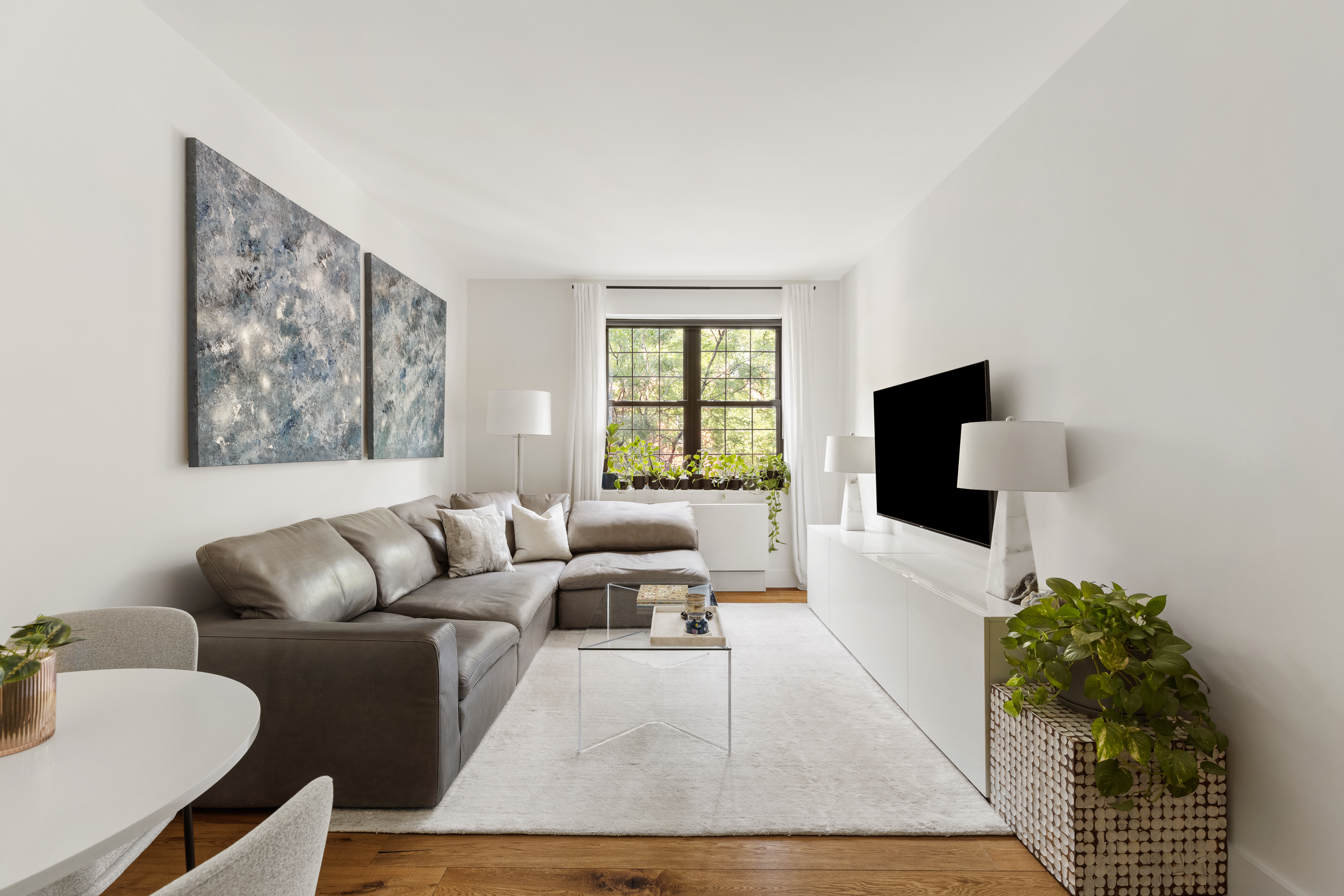 110 Warren Street, Unit B203 Brooklyn, NY 11201 - Photo 4 of 10 a living room with furniture and a flat screen tv