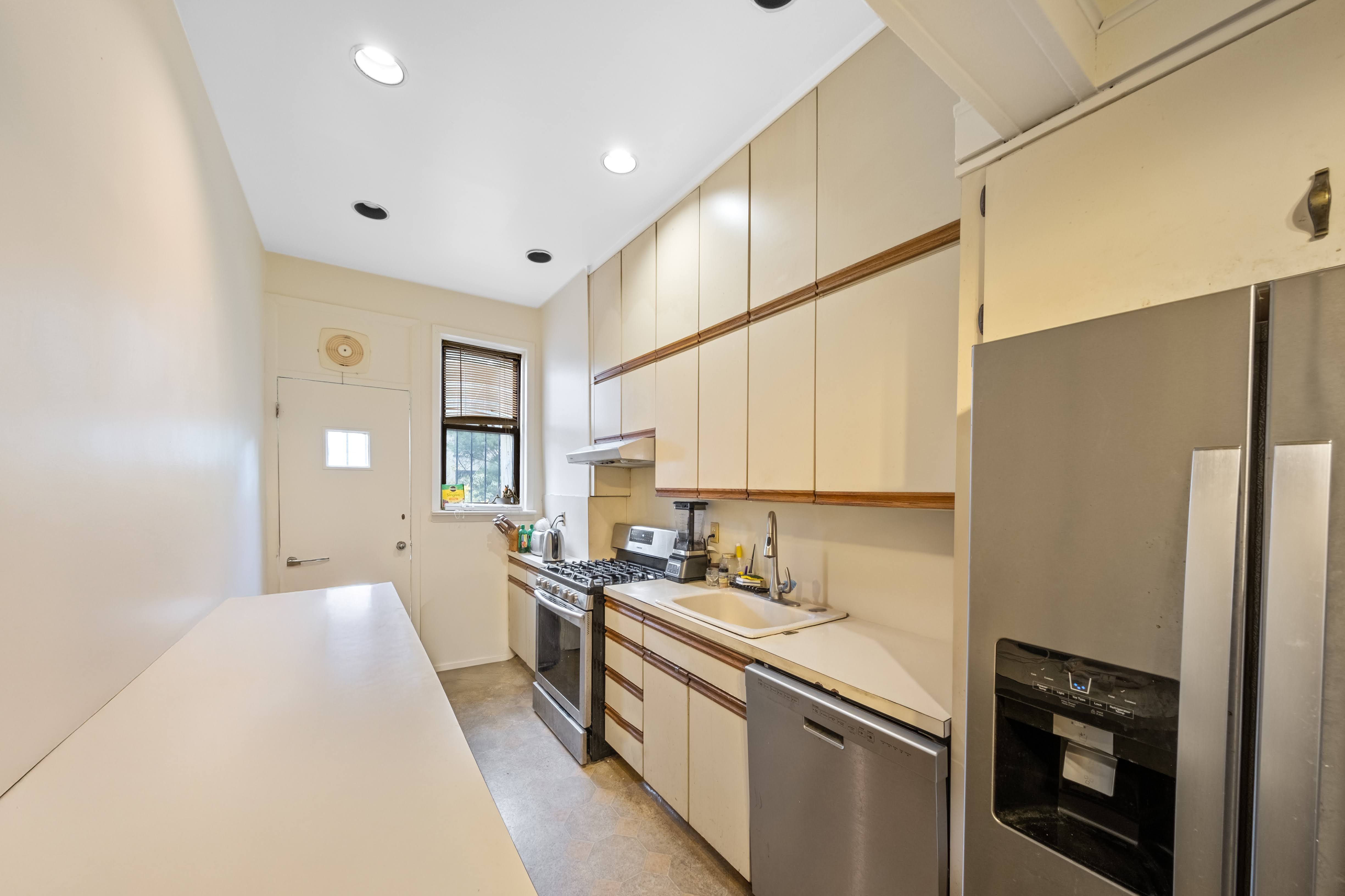 196 Maple Street Brooklyn, NY 11225 - Photo 21 of 31 a kitchen with a sink stainless steel appliances a refrigerator and cabinets