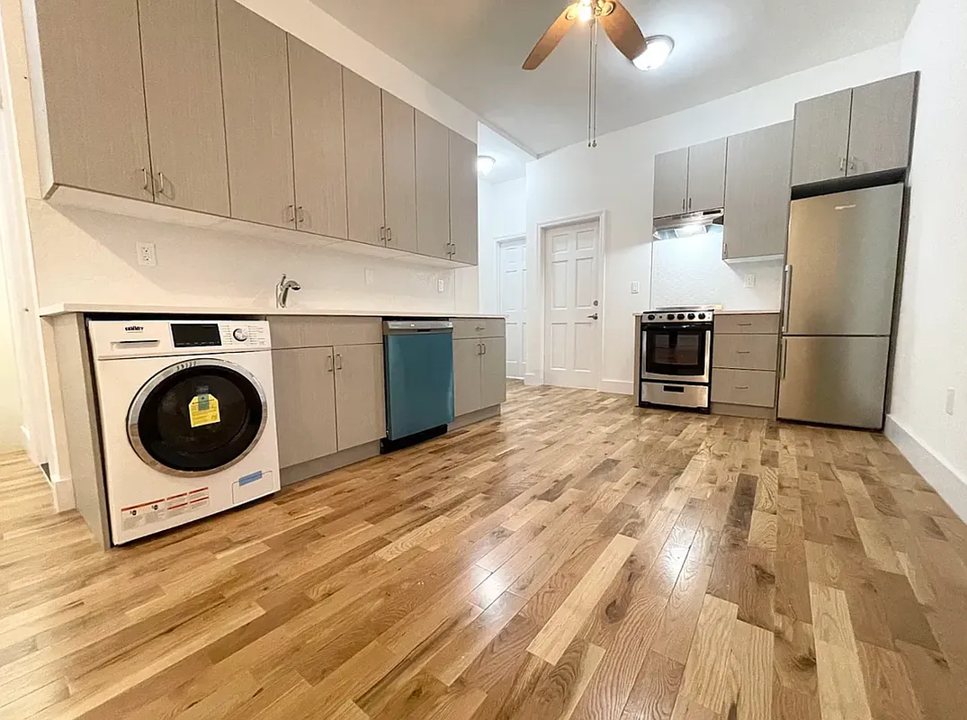 a kitchen with a stove top oven and a refrigerator
