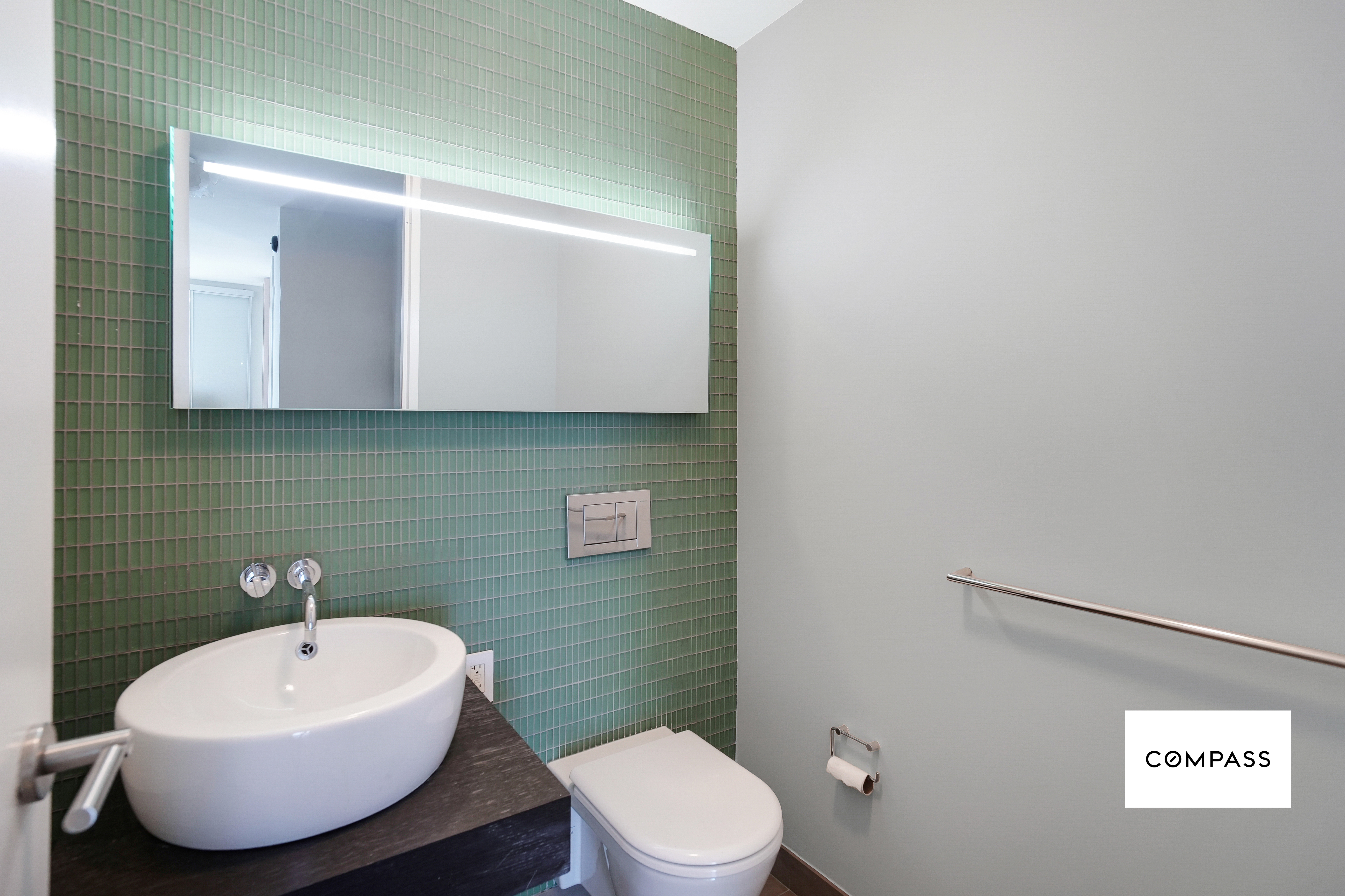 400 East 67th Street, Unit 7B Manhattan, NY 10065 - Photo 7 of 14 a bathroom with a toilet sink and mirror