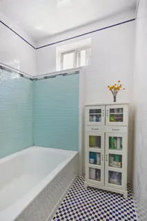 a bathroom with a bathtub and a shower