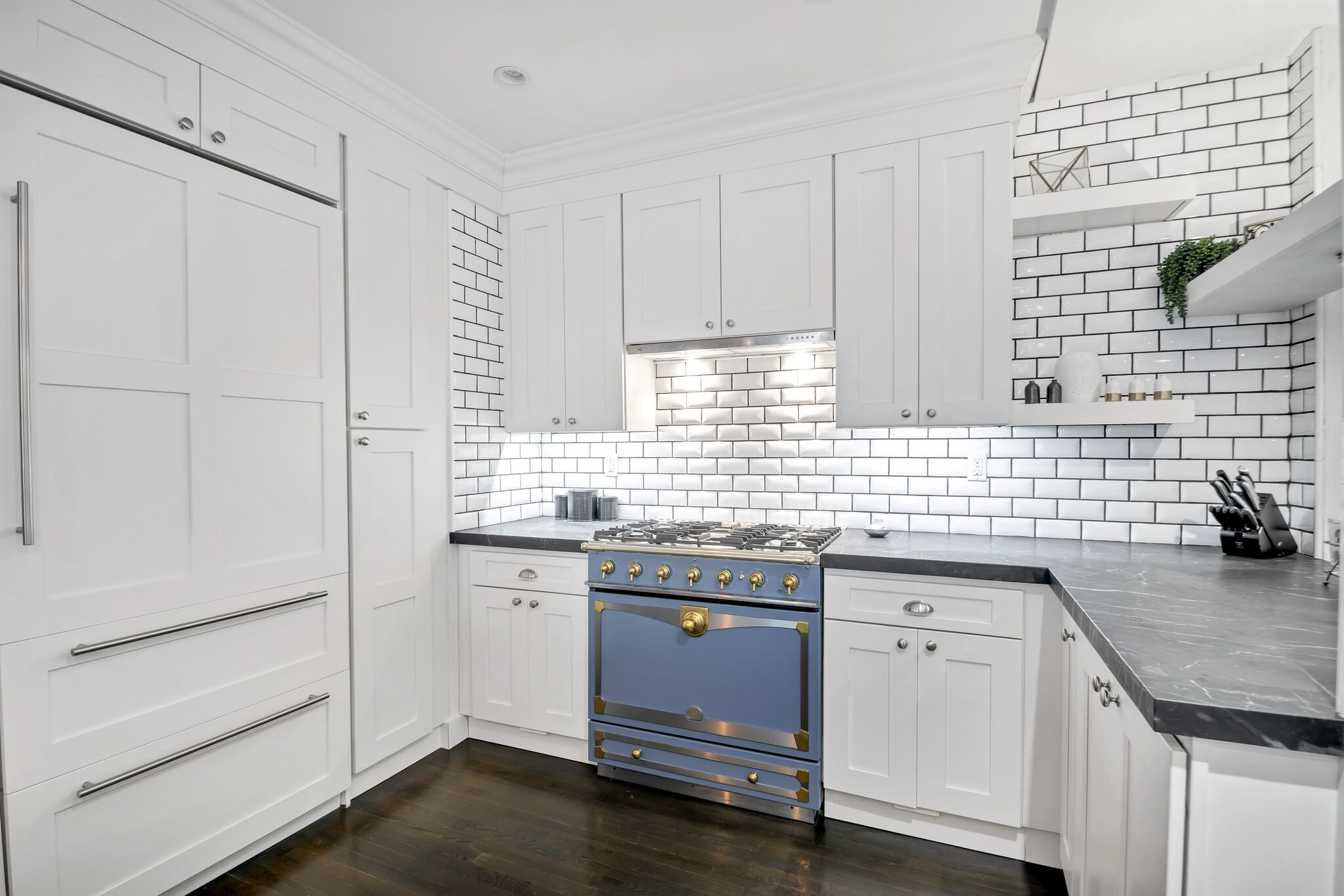 71 Park Avenue, Unit 6B Manhattan, NY 10016 - Photo 5 of 10 a kitchen with granite countertop cabinets sink and wooden floor