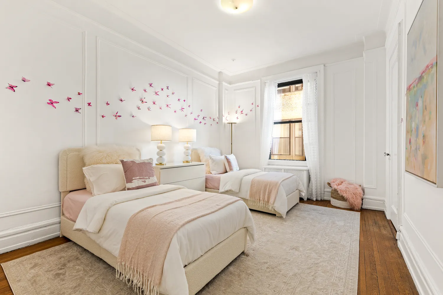 a bed room with two bed and a window