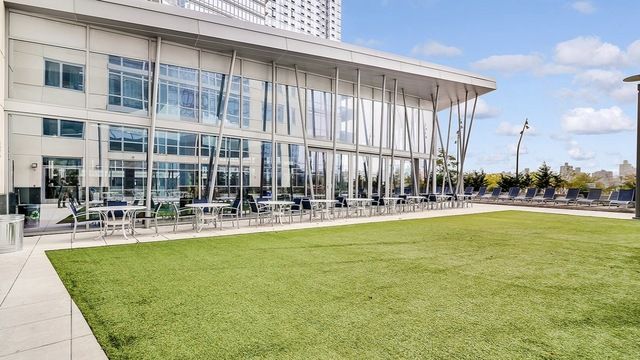 22 North 6th Street, Unit 24F Brooklyn, NY 11249 - Photo 13 of 16 a view of swimming pool with outdoor seating and a garden