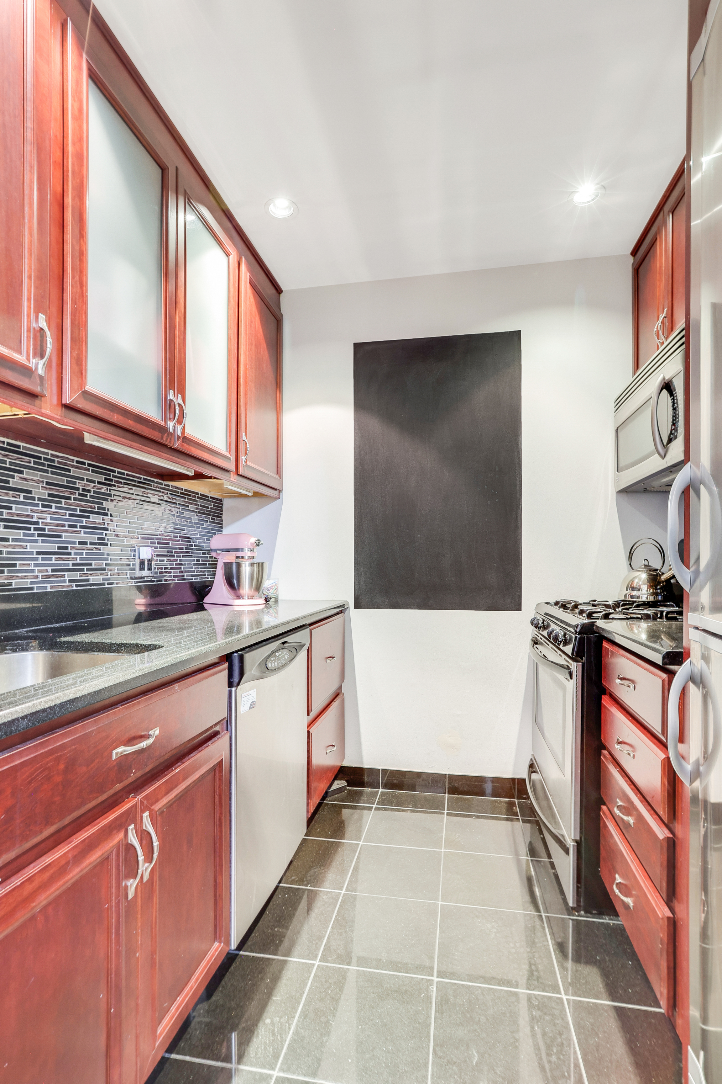 159 Madison Avenue, Unit 4G Manhattan, NY 10016 - Photo 7 of 14 a kitchen with stainless steel appliances granite countertop a stove and a sink