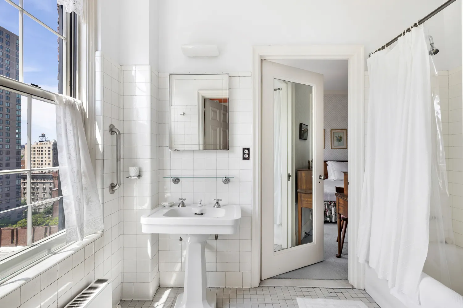 a bathroom with a sink a mirror and a shower