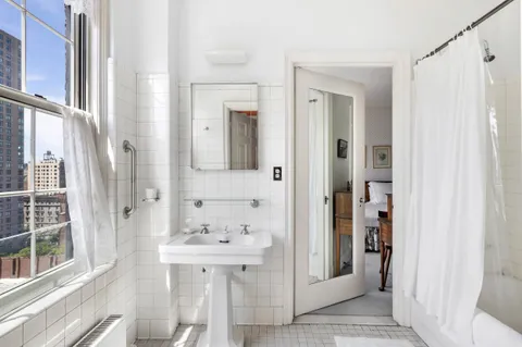 a bathroom with a sink a mirror and a shower