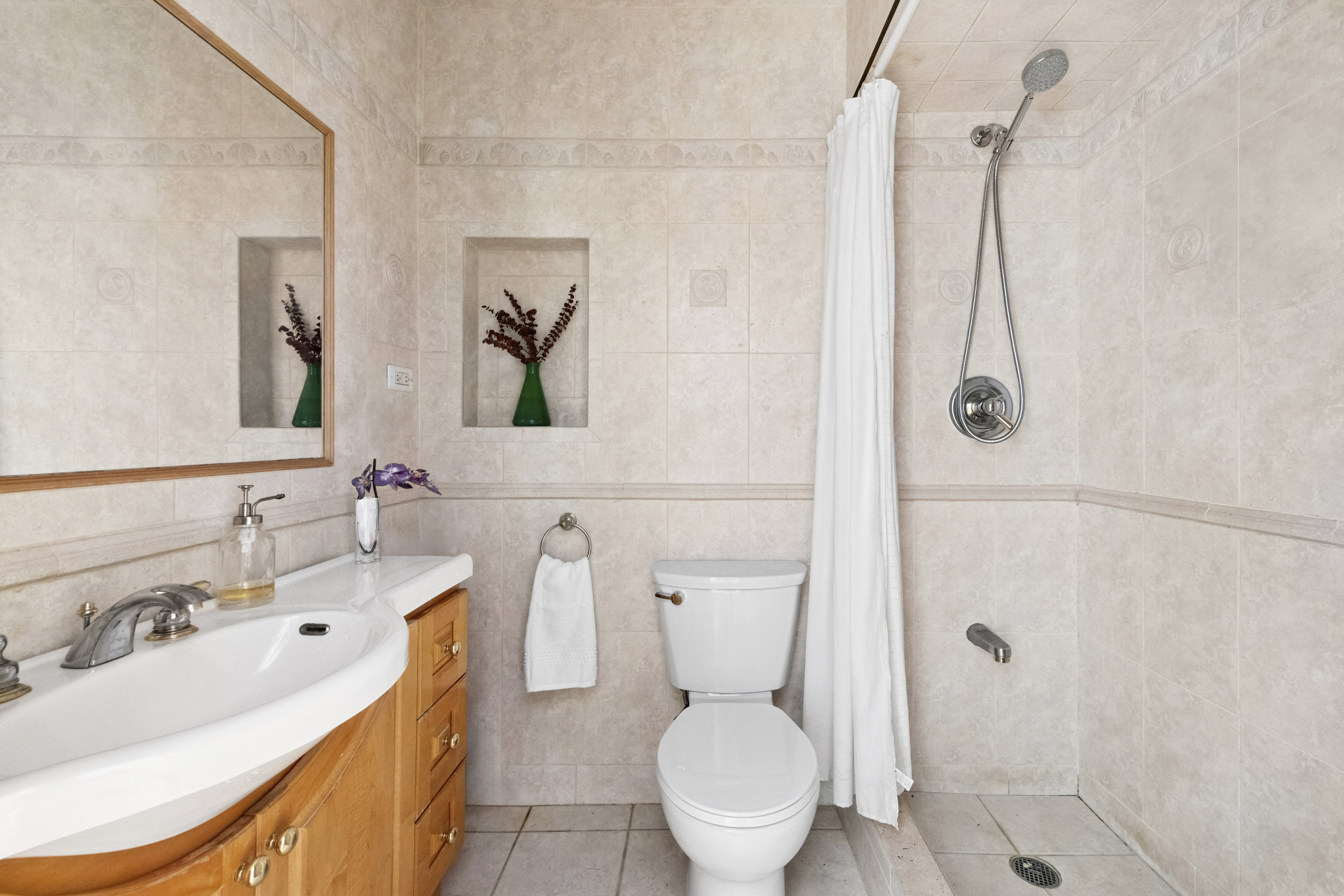225 Central Park West, Unit 916 Manhattan, NY 10024 - Photo 6 of 13 a bathroom with a sink a toilet and shower