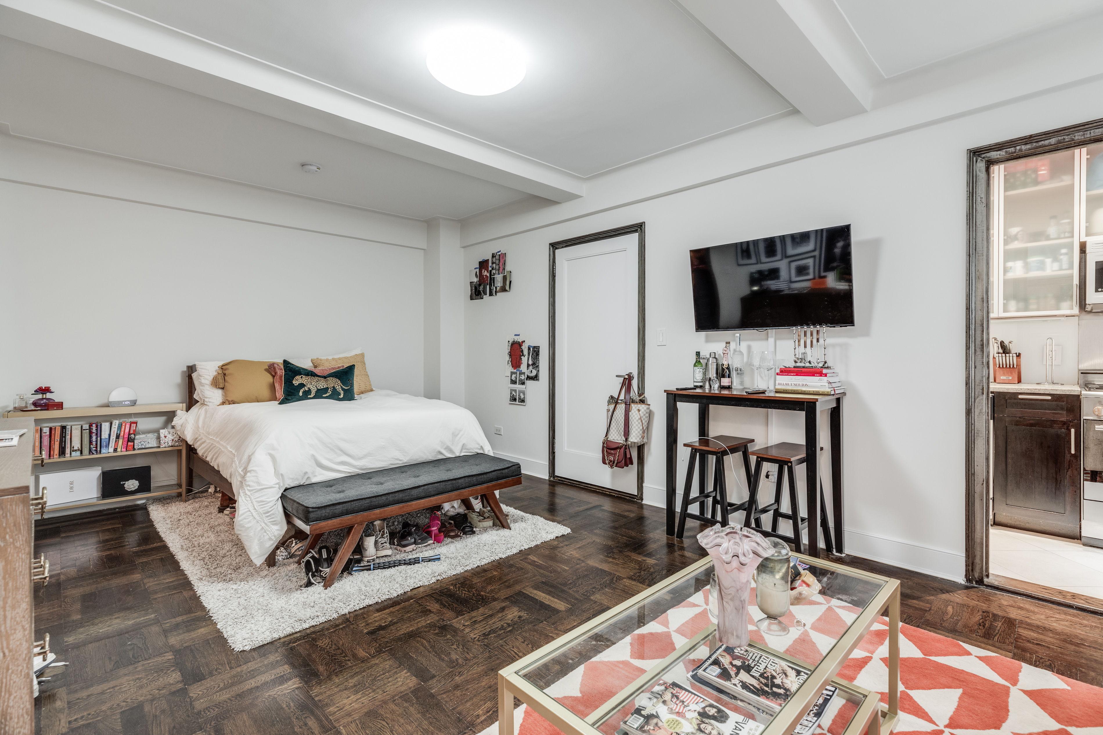 56 7th Avenue, Unit 3G Manhattan, NY 10011 - Photo 2 of 10 a spacious bedroom with a bed and a flat screen tv