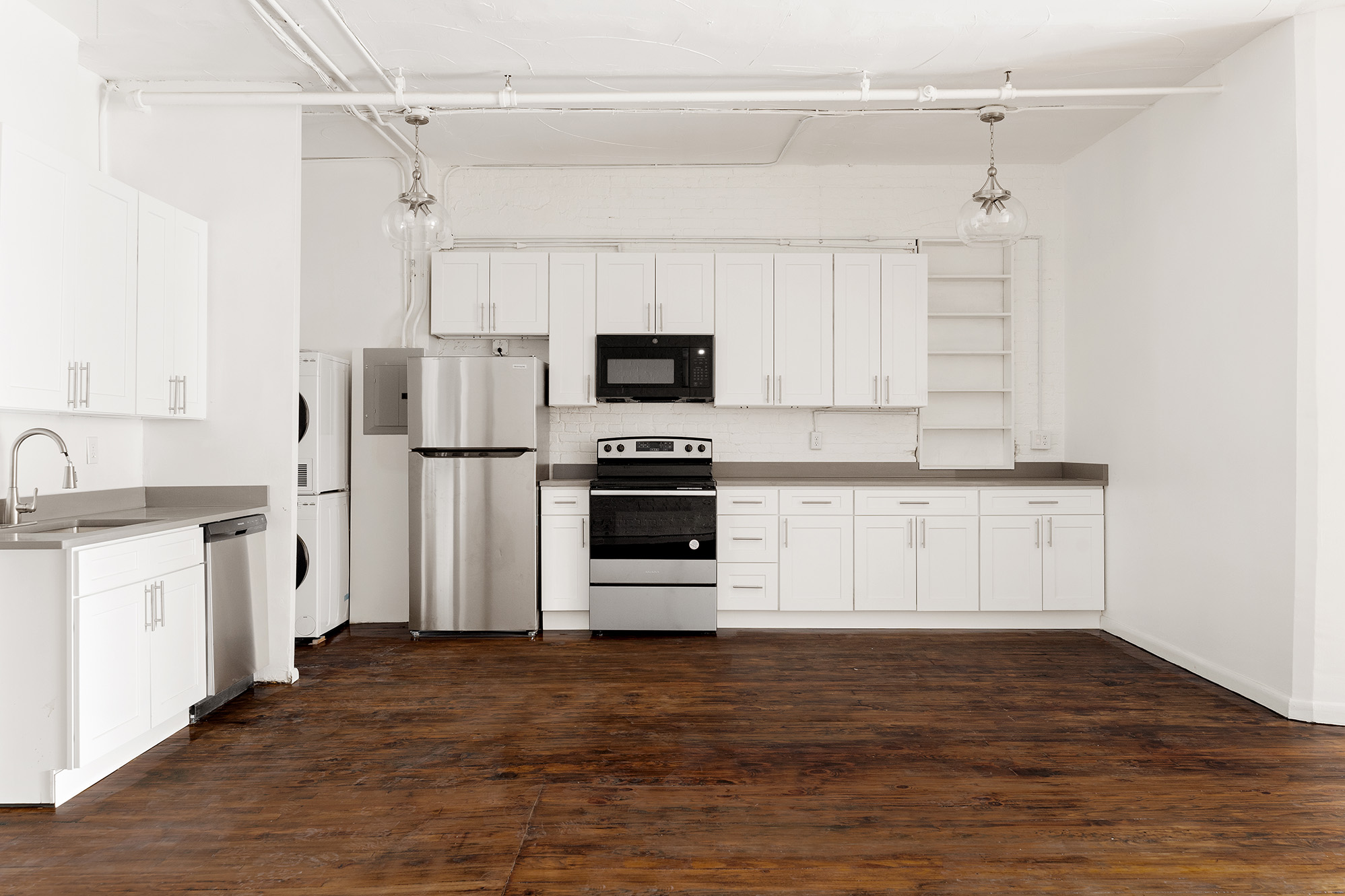 71 8th Avenue, Unit 3R Manhattan, NY 10014 - Photo 3 of 6 a kitchen with a refrigerator stove and white cabinets