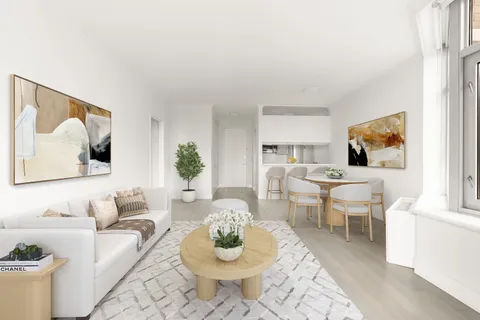 a living room with furniture and a painting on the wall