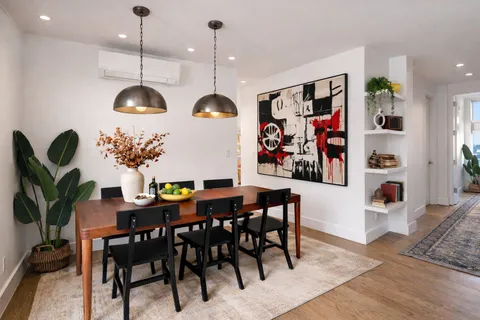 a view of a dining room with furniture and chandelier
