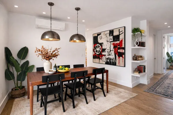 a view of a dining room with furniture and chandelier