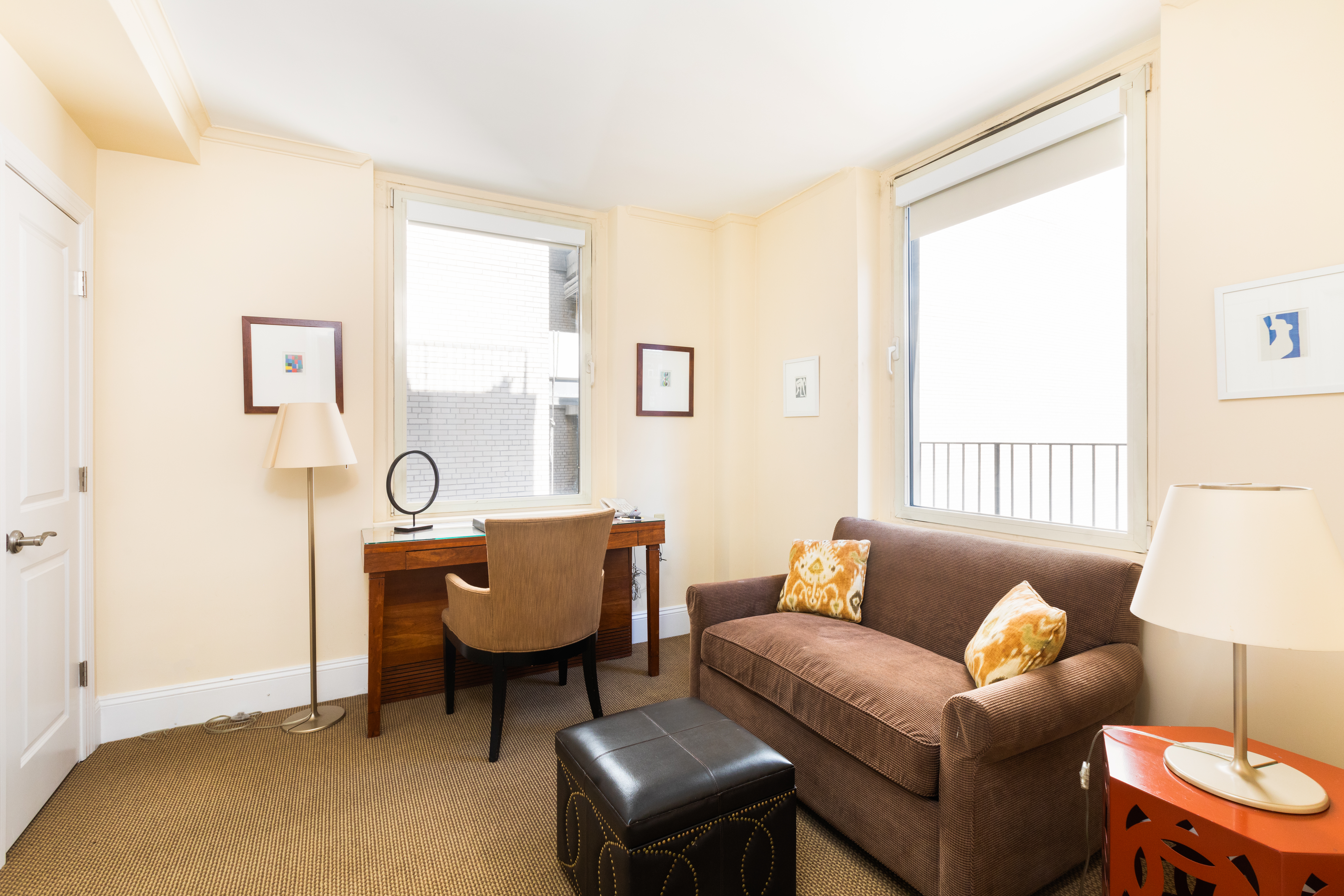 111 East 56th Street, Unit 1705 Manhattan, NY 10022 - Photo 7 of 12 a living room with furniture and a window