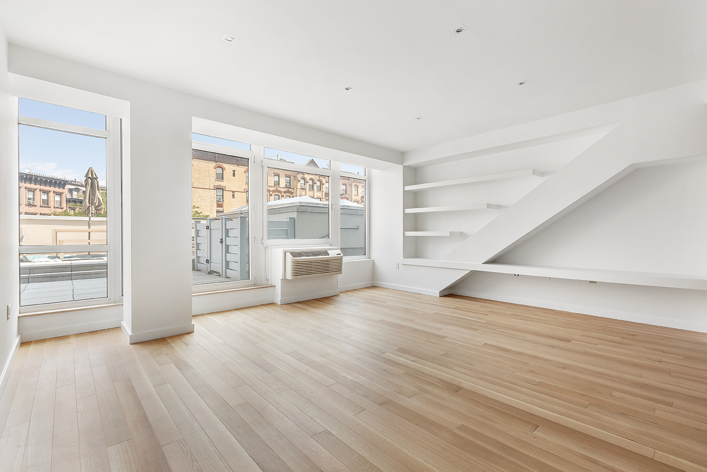 145 Park Place, Unit 3F Brooklyn, NY 11217 - Photo 2 of 9 wooden floor in an empty room with a window