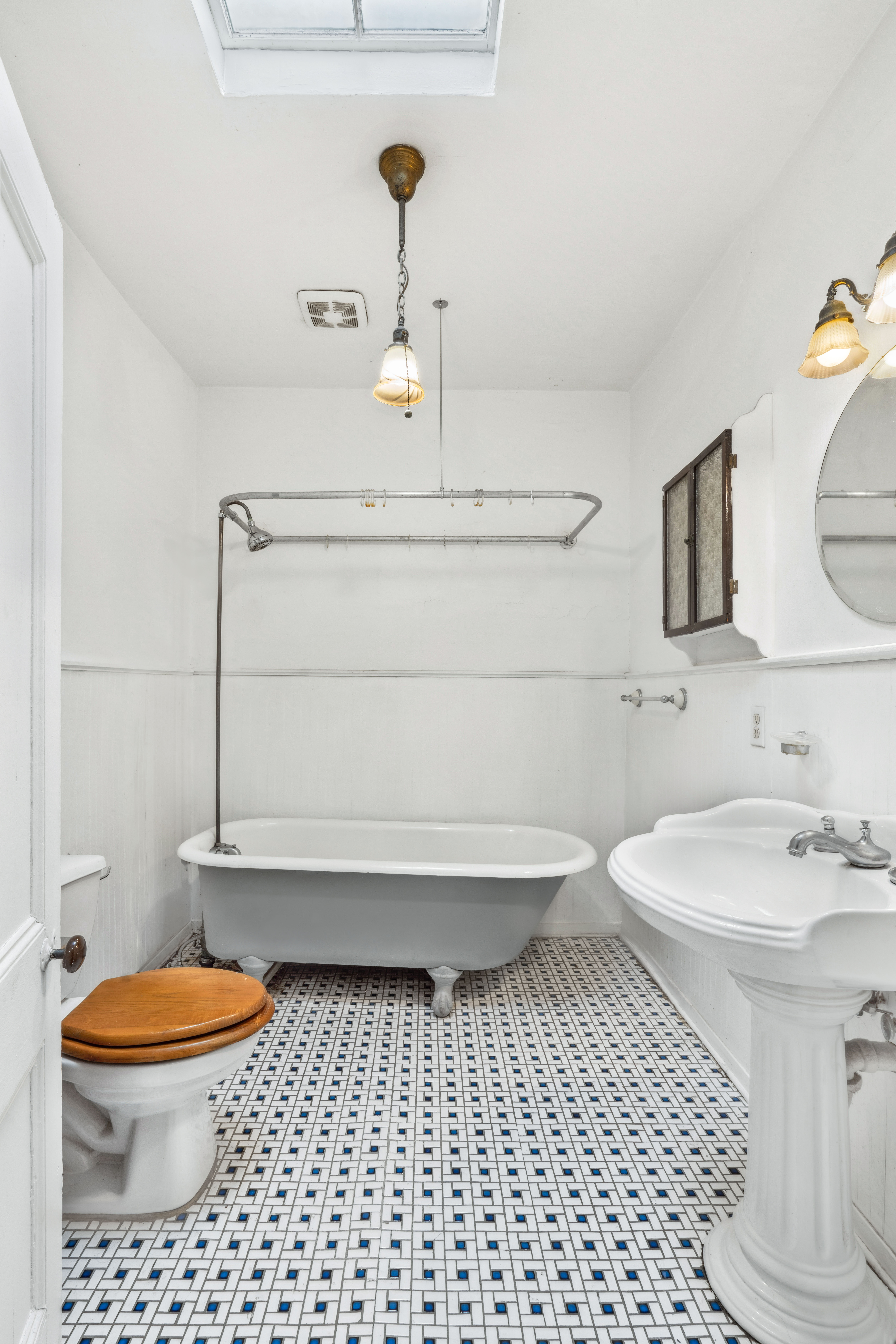 509 6th Avenue Brooklyn, NY 11215 - Photo 16 of 20 a bathroom with a sink a toilet and a mirror