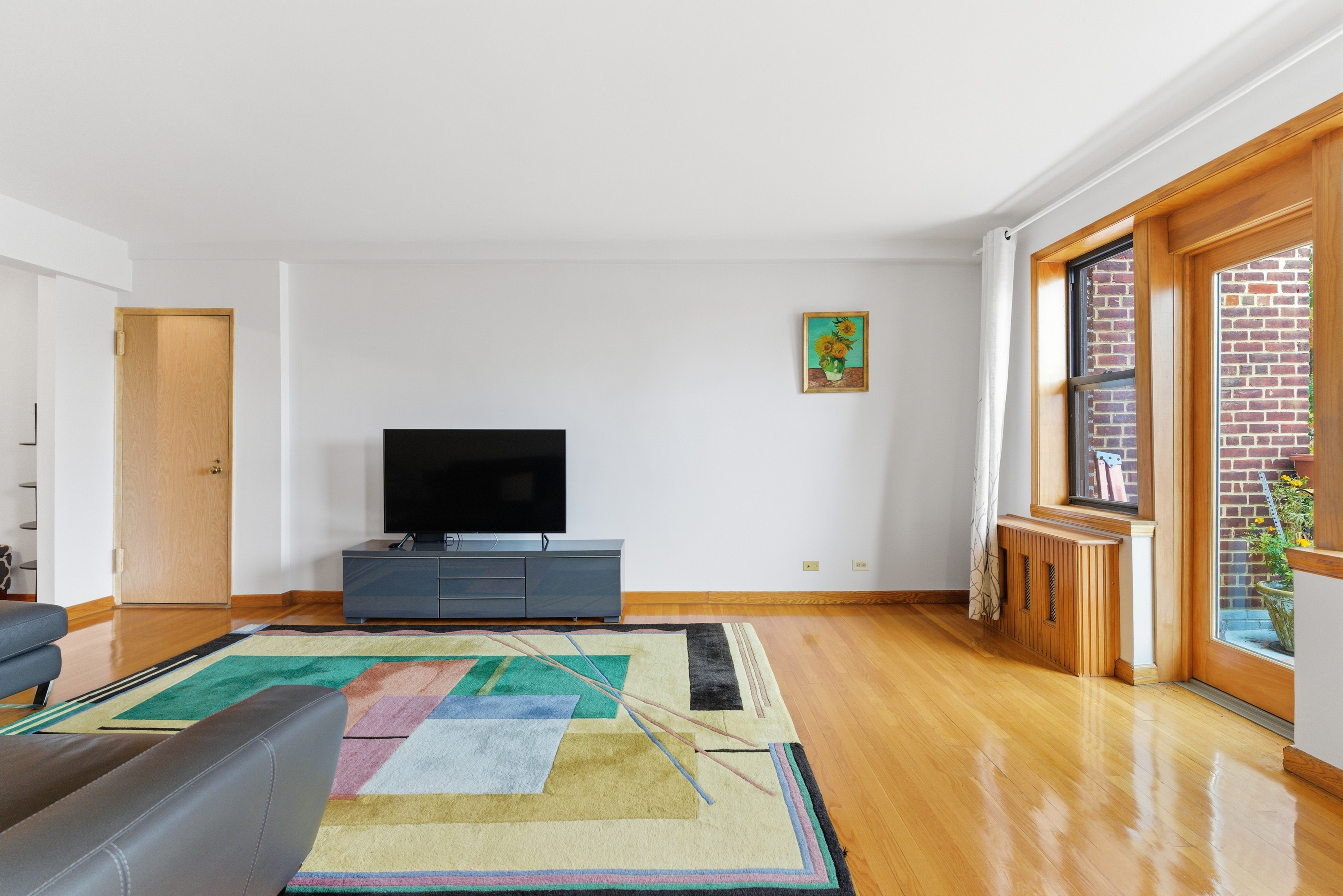 3616 Henry Hudson Parkway, Unit 7GN Bronx, NY 10463 - Photo 6 of 17 a bedroom with a bed and a flat screen tv