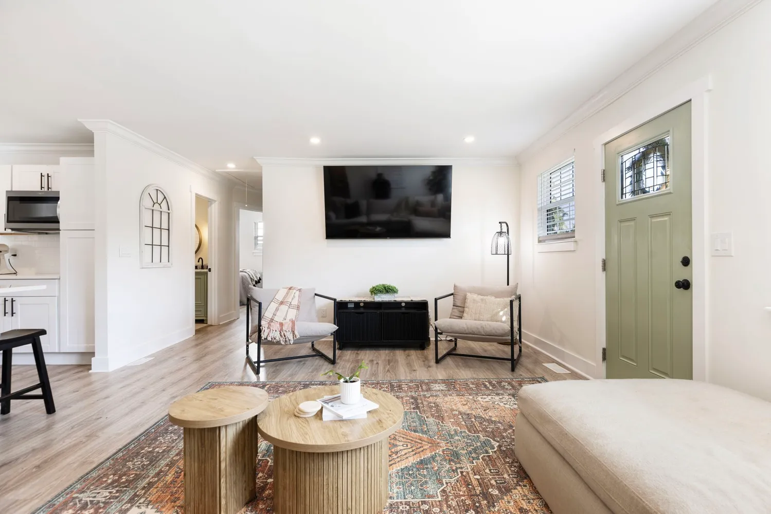 a kitchen with granite countertop a sink dishwasher a stove and a refrigerator with wooden floor