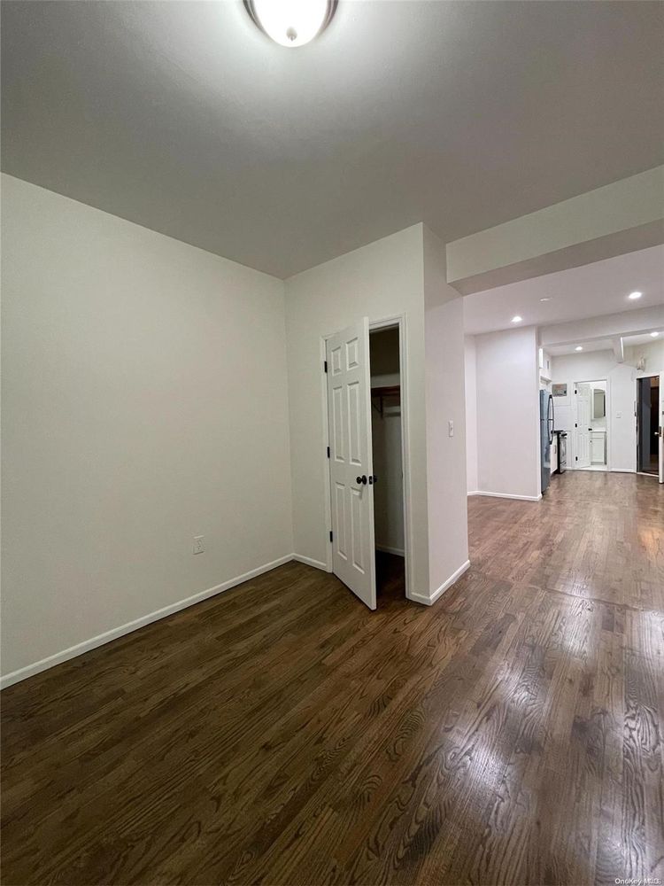 2049 2nd Avenue Manhattan, NY 10029 - Photo 13 of 18 a view of a big room with wooden floor and a window